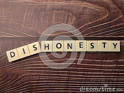 Toys word with the word DISHONESTY Stock Photo
