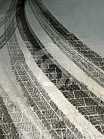 Traces of car wheels on a snowy road. Tire tracks on snow in winter Stock Photo