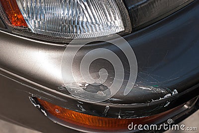 Traces of cracking of paint on the bumper of the car. Which was caused by an accident. Stock Photo