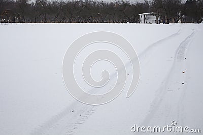 Traces of a vehicle on a level surface untouched snow Stock Photo