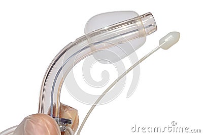 Tracheostomy cannula with inflated cuff and white tracheostomic obturator held in left hand of a doctor in latex sterile glove, wh Stock Photo