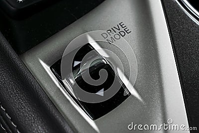 Track control buttons near automatic gear stick of a modern car in black leather interior with stitching. Car interior details. Ca Stock Photo