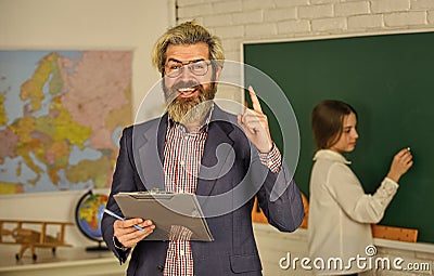 Track student progress. Teaching materials. Who is absent today. Small girl at chalkboard. Back to school. Student and Stock Photo