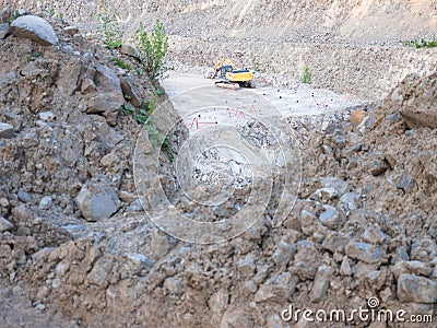 Track type loader is mining stones in opencast mining quarry Stock Photo
