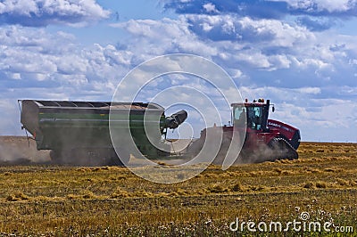 Tractor hauling loaded grain cart Editorial Stock Photo