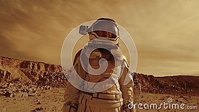 Astronauts searching location for base on Mars Stock Photo