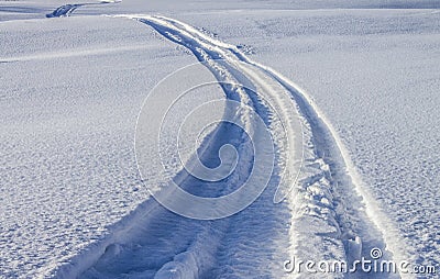 Tracks on the river ice from a snowmobile Stock Photo