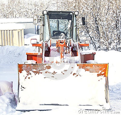 Tractor cleaning snow in winter Stock Photo