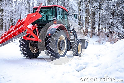 tractor cleans road from snow in the winter Stock Photo