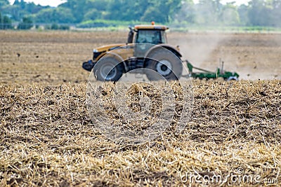 Tractor cultivating the field Stock Photo
