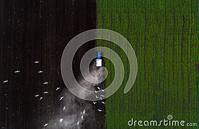 Tractor cultivating field at spring,aerial view Stock Photo