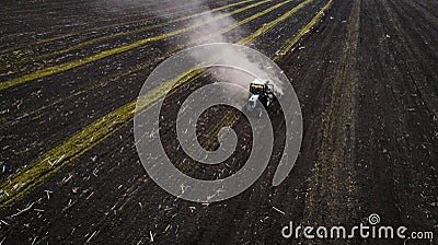 Tractor cultivating field at spring, aerial view Stock Photo