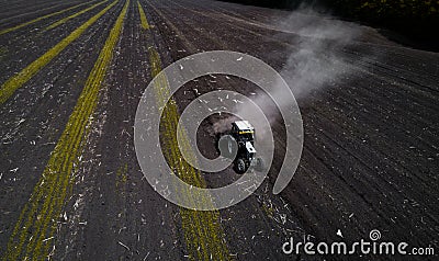 Tractor cultivating field at spring, aerial view Stock Photo