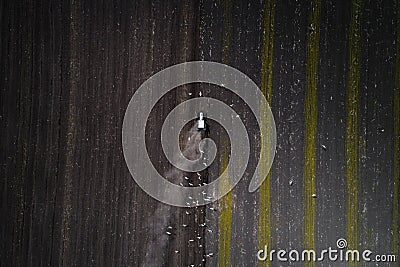 Tractor cultivating field at spring, aerial view Stock Photo