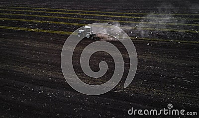 Tractor cultivating field at spring, aerial view Stock Photo