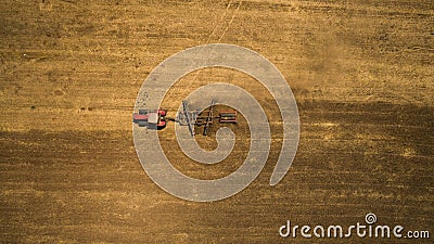 Tractor cultivating and harrowing field at spring season Stock Photo