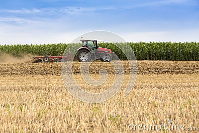 Tractor cultivating wheat stubble field, crop residue Stock Photo