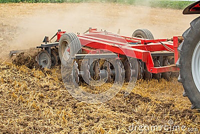 Tractor cultivating wheat stubble field, crop residue Stock Photo