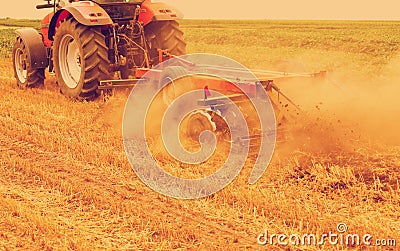 Tractor cultivating wheat stubble field Stock Photo