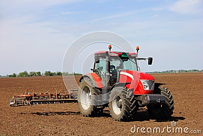 Tractor on a farmland Stock Photo