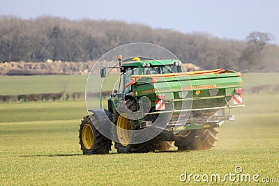 Tractor and fertilizer spreader in field Editorial Stock Photo