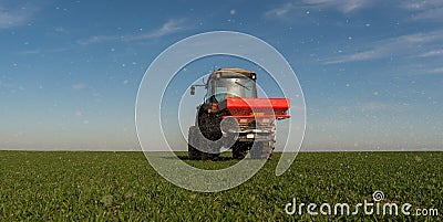 tractor fertilizing in field Stock Photo