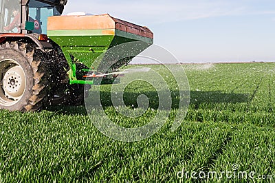 Tractor fertilizing in field Stock Photo