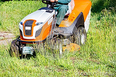 Tractor lawn mower is a powerful garden tool for the maintenance of large areas of park lawns Stock Photo