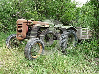 Tractor left in an forest Stock Photo