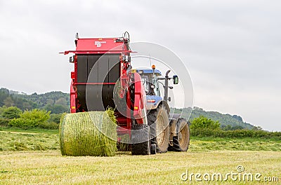 Tractor and lely baler Editorial Stock Photo