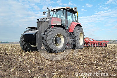 Tractor makes tillage Stock Photo