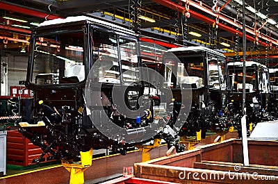 Tractor Manufacture work. Assembly line inside the agricultural machinery factory. Stock Photo