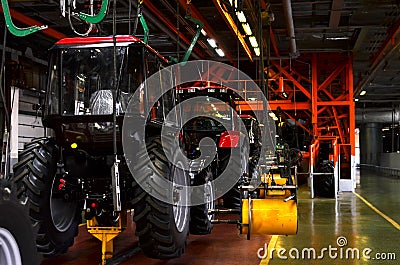 Tractor Manufacture work. Assembly line inside the agricultural machinery factory. Stock Photo