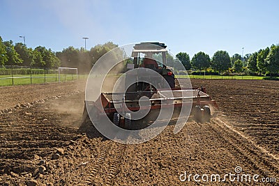 Tractor Mechanical Rake to Gather Stones of the the Land Stock Photo