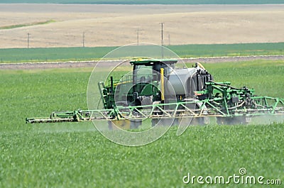 Liquid fertilizer is sprayed on crop field. Editorial Stock Photo