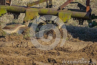 Tractor with plough plow close up Stock Photo