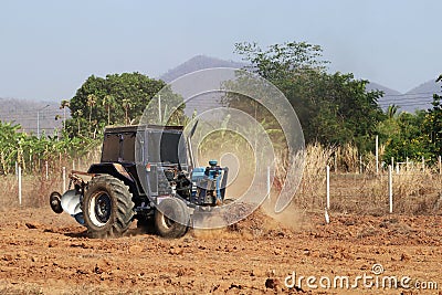 Tractor with Plougher and Grader Working Stock Photo