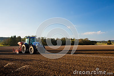 Tractor ploughs field Stock Photo