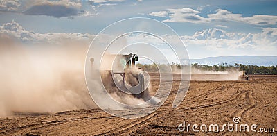 Tractor plowing dry land Stock Photo