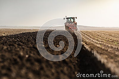 Tractor plowing fields -preparing land for sowings Stock Photo