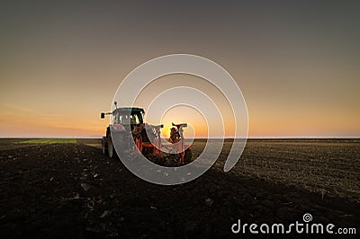 Tractor plowing plow the field Stock Photo