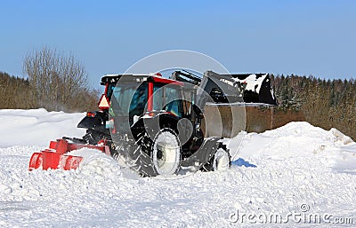 Tractor Plowing Snow on a Yard Stock Photo