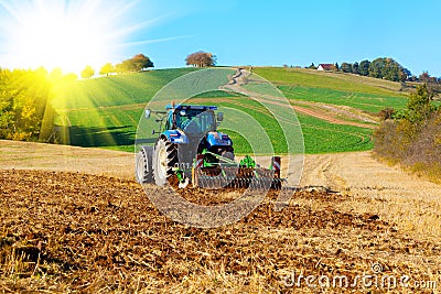 Tractor plows a field Stock Photo