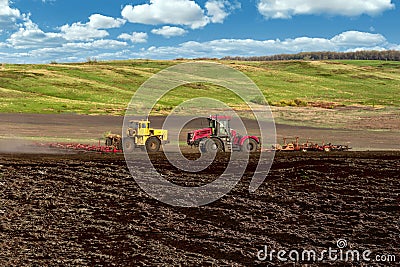 tractor plows the large soil field. Panorama photo rows of soil before planting. Furrows row pattern in a plowed field Stock Photo