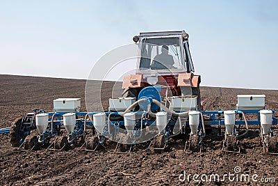 Tractor with sower on the field Stock Photo