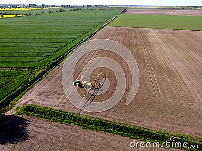 Tractor with sprayer machine working in fields, Zulawy Wislane Stock Photo