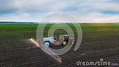 Tractor spraying field at spring Stock Photo