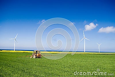 Tractor spraying green field Stock Photo