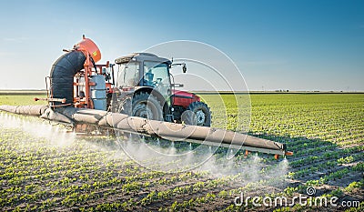 Tractor spraying pesticides Stock Photo