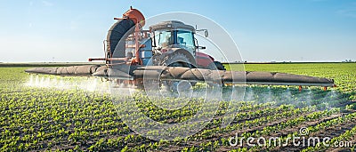 Tractor spraying pesticides Stock Photo